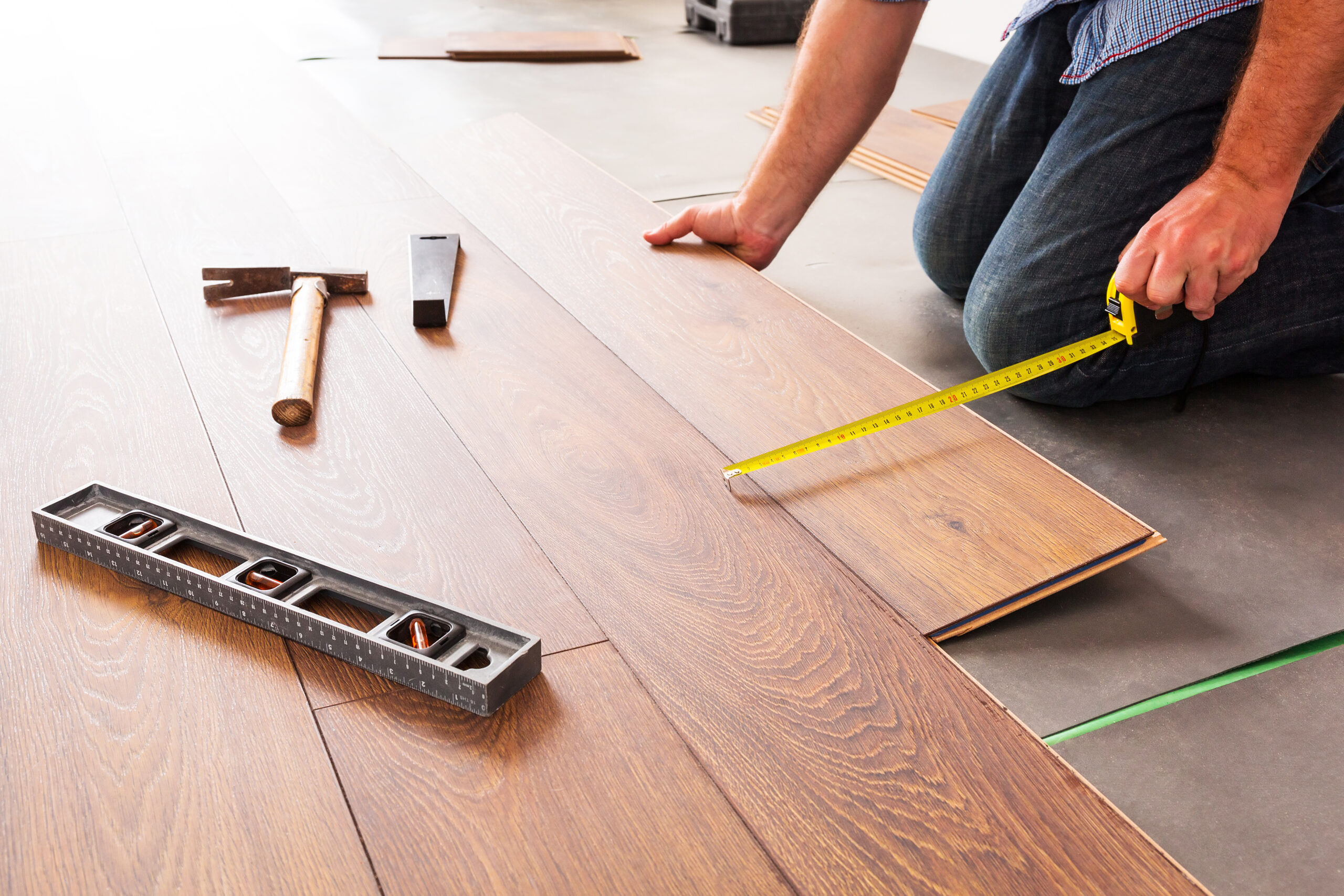 Man,Installing,New,Laminated,Wooden,Floor